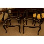 A pair of Chinese open frame armchairs, early 20th Century, painted black with curved backs,