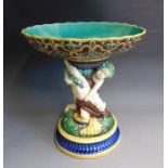 A Minton majolica table centrepiece of two putti supporting a bowl, circa 1863 date code,