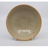 A Chinese Song Dynasty circular bowl, with unglazed rim and straw coloured glaze, 15cm diameter, a