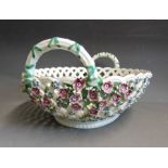 A Chelsea oval pierced twin handled basket, applied with rosettes and flowers, the inside