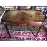 A George III mahogany folding tea table, circa 1780, raised on tapered supports with satinwood