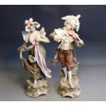 A pair of large Bohemian figures of a gent playing a violin and his lady companion, classically