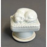 A Staffordshire pottery snuff box with a model of a dog on a cushion, with a screw cover, circa