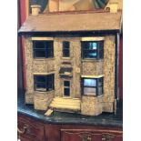 A 1930's large three story dolls house.