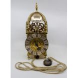 A 20th Century brass lantern clock of typical form, 16cm silvered chapter ring with Roman