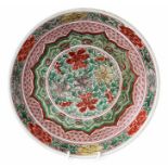 A Chinese polychrome porcelain dish, Kangxi period, 1662-1722, central peony roundel within formal