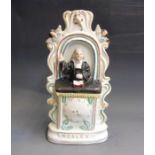 A Staffordshire John Wesley pulpit group, standing on a clock face base, circa 1860, 29cm high