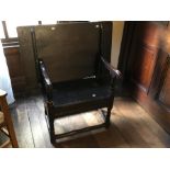 A 17th century and later oak monks bench, hinge cleated top, scrolled arms, small box seated with
