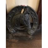 A 20th Century large cast iron horse sign, a horses head centred border with horseshoe shape
