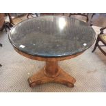 A 19th C blond wood circular centre table with black marble top, tapered column, curved triangular
