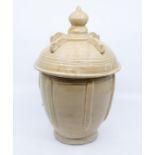 A Chinese pottery granary jar, perhaps Han Dynasty, of semi-ovoid shape with a domed integral cover,