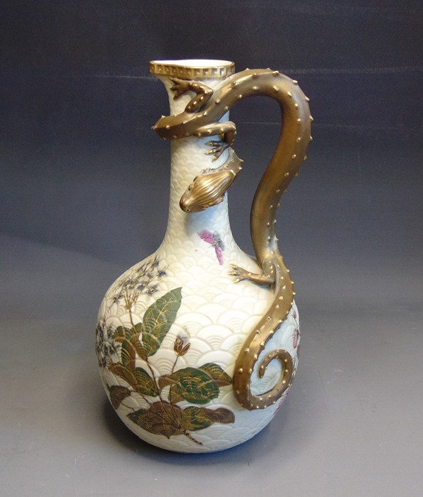 A Royal Worcester ewer, ivory scaled painted with green and gilt leaves, flowers and butterflies.