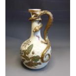 A Royal Worcester ewer, ivory scaled painted with green and gilt leaves, flowers and butterflies.