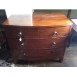 A George III mahogany bow front chest of drawers, circa 1800, square inlay pattern above three