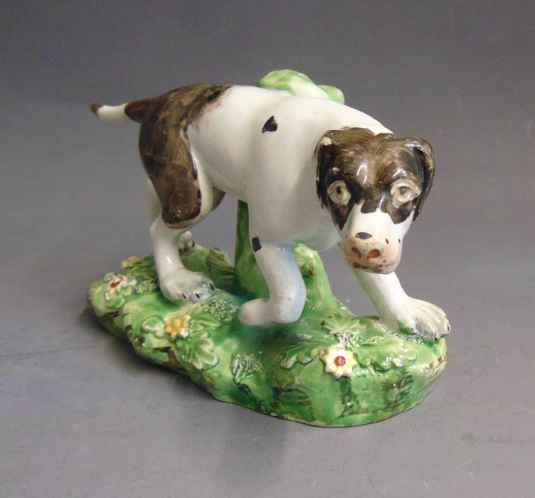 A Staffordshire pearlware model of a pointer, standing on a grassy base, circa 1820, 16cm wide,  9cm - Image 3 of 5