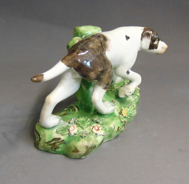 A Staffordshire pearlware model of a pointer, standing on a grassy base, circa 1820, 16cm wide,  9cm - Image 2 of 5