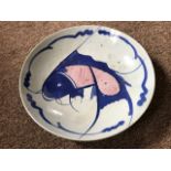 A late 19th Century Japanese export circular dish, painted in blue and iron red with a carp,