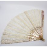 An Mid Victorian fan, heavy carved and gilt decoration, mother of pearl sticks, with Brussels lace