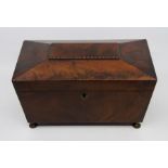 A Regency mahogany tea caddy, circa 1820, of sarcophagus form, triple division interior with covered