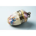 A 19th Century European porcelain vinaigrette of egg form, painted with Watteau style figure scenes,