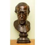 A late 19th Century bronze bust of Benjamin Disraeli, mounted on a serpentine socle, all-over dark