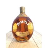 A bottle of Dimple Haige blended whisky, in the trademark bottle, sealed with the original spring