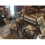 An Edwardian Art Nouveau seven piece mahogany salon suite, comprising settee, a pair of armchairs