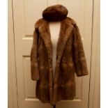 A dark brown squirrel coat and a 3/4 Musquash 1974 coat with matching hat (3)