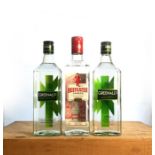 Three bottles of Dry Gin, including two bottles of Greenall's and one bottle of Beefeater.