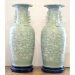 A large pair of Chinese celadon glazed twin handled baluster vases, Qing Dynasty (19th Century),