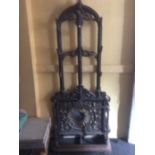 A Victorian cast iron hall stand, possibly by Coalbrookdale, with 9 hat hooks over umbrella and
