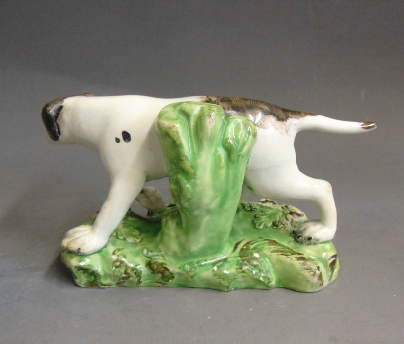 A Staffordshire pearlware model of a pointer, standing on a grassy base, circa 1820, 16cm wide,  9cm - Image 4 of 5