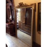 A 19th century gilt wood over mantle mirror with egg and dart moulded frame.