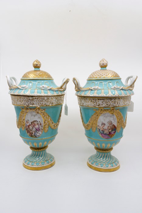 A pair of Augustus Rex vases and covers. Turquoise ground with painted panels of courting couples,