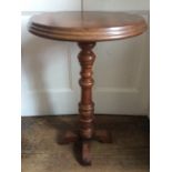 A Victorian mahogany pedestal occasional table, the circular top raised on a turned column, standing