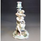 A Sitzendorf late 19th Century candlestick figure of a maiden and a putti, blue H mark, impressed