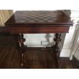 An early Victorian Gillows rosewood fold-over games table, the top inlaid with a chequered top of