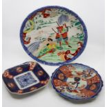 A Japanese porcelain small charger, circa 1910, printed and painted in colours with Samurai and