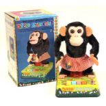 Dancing Merry Chimp: A boxed, battery operated, tin and plush, Dancing Merry Chimp, Made by C.K,