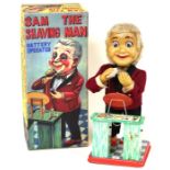 Sam the Shaving Man: A boxed, battery operated, tinplate, Sam the Shaving Man, Made by Plaything,