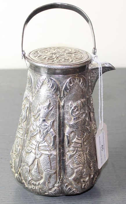 A South East Asian white metal coffee pot, of circular tapering form, with swing handle and pull-off