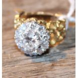 An 18ct. gold and diamond cluster ring, set central round brilliant cut diamond (approx weight 1.