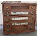 A Yeomans' Needles Astwood oak haberdashery advertising cabinet, having five drawers each fitted