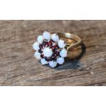 A 9ct. gold, opal and garnet cluster ring, shank hallmarked London 1971. (gross weight 4.5g)