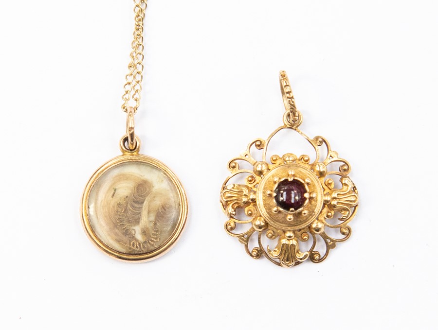 A 19th century circular mourning pendant, unmarked assessed as approx 15ct, on a later 9ct gold