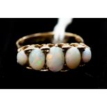 A 9ct gold and opal stone set ring, comprising five oval opals, size O, total gross weight approx