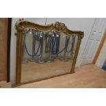 A large gilt framed over mantel mirror