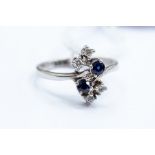 **REOFFER A&C NOV £80-£120** A sapphire and diamond ring, cross over shoulders with round cut