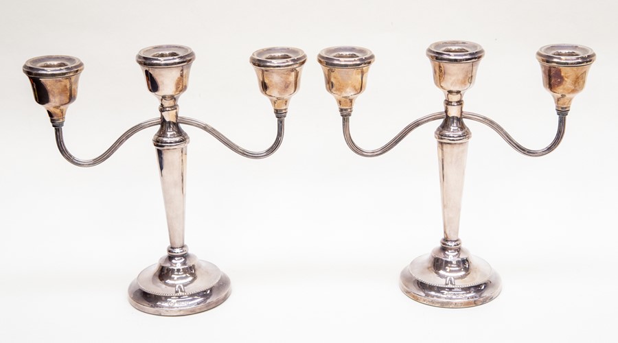**REOFFER IN A&C NOV £180-£200** A pair of Birmingham silver candelabras, filled, 1978, maker A.T