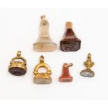 A collection of six antique seals in unmarked yellow metal and gilt metal,  some set with glass